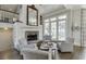 Relaxing sitting area features stone fireplace, comfortable seating, and access to the outside at 3980 Saint Elisabeth Sq, Duluth, GA 30096