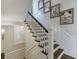 Staircase with hardwood steps and white wood risers, enhanced with framed art on the adjacent wall at 3980 Saint Elisabeth Sq, Duluth, GA 30096