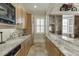 An expansive wet bar features light wood cabinets, tile backsplash and granite countertops at 3980 Saint Elisabeth Sq, Duluth, GA 30096
