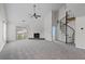Bright living room with fireplace, spiral staircase, high ceilings, and sliding glass doors to a balcony at 903 Bridge Se Ln, Smyrna, GA 30082