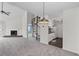 Inviting living room with a fireplace, spiral staircase, and bright kitchen at 903 Bridge Se Ln, Smyrna, GA 30082