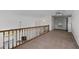 Open loft area featuring neutral carpeting, ample closet space, a ceiling fan, and an overlooking view of the living room at 903 Bridge Se Ln, Smyrna, GA 30082