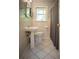 A bathroom featuring a pedestal sink, toilet, tile flooring, and a window at 1263 Briarcliff Ne Rd, Atlanta, GA 30306