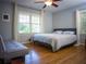 This bedroom boasts a large window, hardwood floors, a ceiling fan, and neutral tones at 1263 Briarcliff Ne Rd, Atlanta, GA 30306