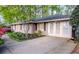 Side view of a charming home with an extra parking area and manicured landscaping adding to its appeal at 1263 Briarcliff Ne Rd, Atlanta, GA 30306