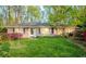 Charming single-story home with lush lawn, beautiful landscaping, and blooming azaleas enhancing its curb appeal at 1263 Briarcliff Ne Rd, Atlanta, GA 30306
