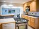 Bright kitchen features wood cabinets, stainless steel stove, and breakfast bar to living area at 1263 Briarcliff Ne Rd, Atlanta, GA 30306