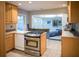 Bright kitchen features wood cabinets, stainless steel stove, and breakfast bar to living area at 1263 Briarcliff Ne Rd, Atlanta, GA 30306