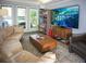 Relax in this living room featuring a slate floor, large windows, and modern entertainment center at 1263 Briarcliff Ne Rd, Atlanta, GA 30306