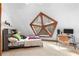 A carpeted bedroom with a unique angular window providing natural light, complete with a desk at 1275 S Deshon Rd, Lithonia, GA 30058