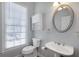 Charming bathroom with pedestal sink, decorative mirror, and ample natural light at 1286 Creekside Se Ter, Smyrna, GA 30082