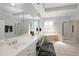 Bright bathroom featuring double vanity, soaking tub, and walk-in shower at 1286 Creekside Se Ter, Smyrna, GA 30082