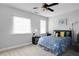 Bedroom features neutral walls, a ceiling fan, and bright natural light at 1286 Creekside Se Ter, Smyrna, GA 30082