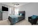 Bedroom features neutral walls and carpet, ceiling fan, and corner chair at 1286 Creekside Se Ter, Smyrna, GA 30082
