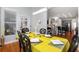 Elegant dining room featuring hardwood floors, modern lighting, and a view of the adjacent kitchen and living room at 1286 Creekside Se Ter, Smyrna, GA 30082