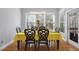 Inviting dining area with a modern chandelier, hardwood floors, and a large window overlooking a green backyard at 1286 Creekside Se Ter, Smyrna, GA 30082