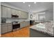 Well-lit kitchen features granite counters, stainless steel appliances, mosaic backsplash and hardwood flooring at 1286 Creekside Se Ter, Smyrna, GA 30082