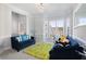 Bright living room with plush carpet, stylish sofas, and a large bay window at 1286 Creekside Se Ter, Smyrna, GA 30082