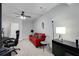 Living room with neutral walls and carpet, bright red couch, and a ceiling fan at 1286 Creekside Se Ter, Smyrna, GA 30082
