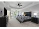 Spacious main bedroom with tray ceilings, plush carpet, and sitting area by windows at 1286 Creekside Se Ter, Smyrna, GA 30082