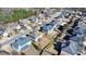 Aerial view of a landscaped property showcasing a fenced backyard, stone patio and outdoor living space at 1465 Forest Brook Trl, Cumming, GA 30041