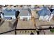 Overhead view of the house with a patio cover, grassy yard, wooden fence, and neighborhood at 1465 Forest Brook Trl, Cumming, GA 30041