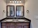 Modern bathroom vanity featuring dual sinks, framed mirrors and granite countertops at 1465 Forest Brook Trl, Cumming, GA 30041