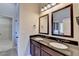 Bathroom featuring double sinks with dark cabinets and framed mirrors at 1465 Forest Brook Trl, Cumming, GA 30041