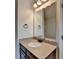 Bathroom vanity featuring granite countertops, a mirror and dark wood cabinets at 1465 Forest Brook Trl, Cumming, GA 30041
