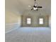 Large bedroom showcases a vaulted ceiling, neutral color scheme, and carpeted flooring at 1465 Forest Brook Trl, Cumming, GA 30041