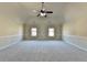 Large bedroom with neutral carpet, paint, vaulted ceiling and fan, providing a calm and spacious atmosphere at 1465 Forest Brook Trl, Cumming, GA 30041
