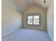 Bedroom with neutral carpet and paint and a large window with a view at 1465 Forest Brook Trl, Cumming, GA 30041
