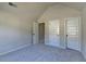 Bedroom with neutral paint and carpet boasts vaulted ceiling and three doors at 1465 Forest Brook Trl, Cumming, GA 30041