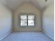Bedroom with neutral paint and carpet and a large window overlooking the street at 1465 Forest Brook Trl, Cumming, GA 30041