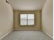 Neutral bedroom showcasing a large window providing ample natural light and a calm atmosphere at 1465 Forest Brook Trl, Cumming, GA 30041
