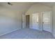 Bedroom with neutral color scheme and two white paneled doors ready for personal decoration at 1465 Forest Brook Trl, Cumming, GA 30041