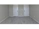 Neutral carpeted bedroom offering two white panel doors, awaiting your personal touch at 1465 Forest Brook Trl, Cumming, GA 30041