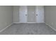 Bedroom features neutral paint and carpet, and two doors at 1465 Forest Brook Trl, Cumming, GA 30041