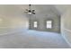 Large bedroom with neutral carpet, paint, vaulted ceiling and fan, providing a calm and spacious atmosphere at 1465 Forest Brook Trl, Cumming, GA 30041