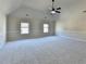 Spacious bedroom featuring a vaulted ceiling, neutral walls and plush carpeting at 1465 Forest Brook Trl, Cumming, GA 30041