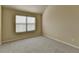 Bright bedroom featuring a window and neutral carpet providing a cozy atmosphere at 1465 Forest Brook Trl, Cumming, GA 30041