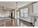 Sun-filled dining area with hardwood floors, large windows, and easy access to the kitchen and living spaces at 1465 Forest Brook Trl, Cumming, GA 30041