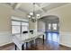 Dining room with hardwood floors, coffered ceilings, and a view of the living room at 1465 Forest Brook Trl, Cumming, GA 30041