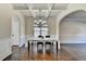 Dining Room with coffered ceilings, decorative wall trim, a window with wood blinds and an arched entry to another room at 1465 Forest Brook Trl, Cumming, GA 30041