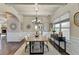 Dining room with hardwood floors, coffered ceilings, and elegant lighting fixture at 1465 Forest Brook Trl, Cumming, GA 30041