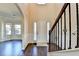 Elegant foyer featuring hardwood floors, soaring ceilings, and staircase with decorative iron balusters at 1465 Forest Brook Trl, Cumming, GA 30041