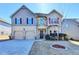 Charming two-story home featuring a well-manicured lawn, two-car garage, and inviting front entrance at 1465 Forest Brook Trl, Cumming, GA 30041
