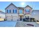 Charming two-story home featuring a well-manicured lawn, two-car garage, and inviting front entrance at 1465 Forest Brook Trl, Cumming, GA 30041