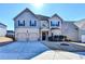 Charming two-story home featuring a well-manicured lawn, two-car garage, and inviting front entrance at 1465 Forest Brook Trl, Cumming, GA 30041