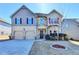 Charming two-story home featuring a two-car garage, stone accents, and well-maintained landscaping at 1465 Forest Brook Trl, Cumming, GA 30041